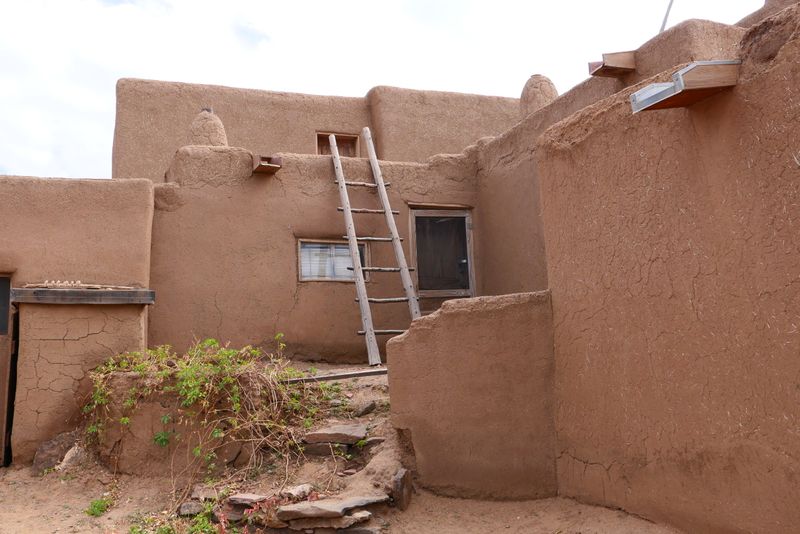 Historic adobe home at Taos Pueblo, New Mexico in warm afternoon light